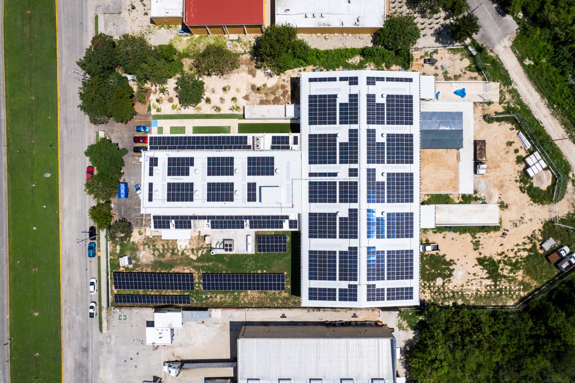 Aerial view of rooftop and ground-mount solar panels at a chocolate factory in Yucatán, Mexico